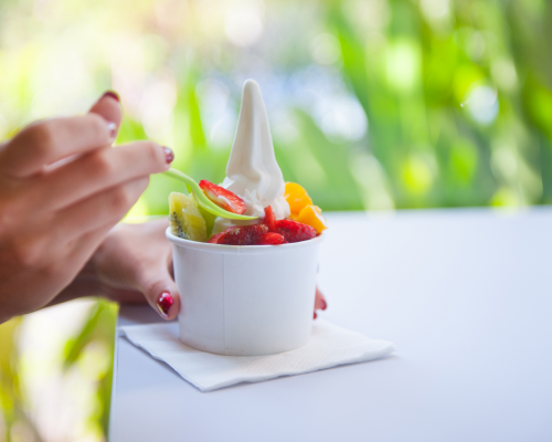 Eating frozen yogurt with fruit